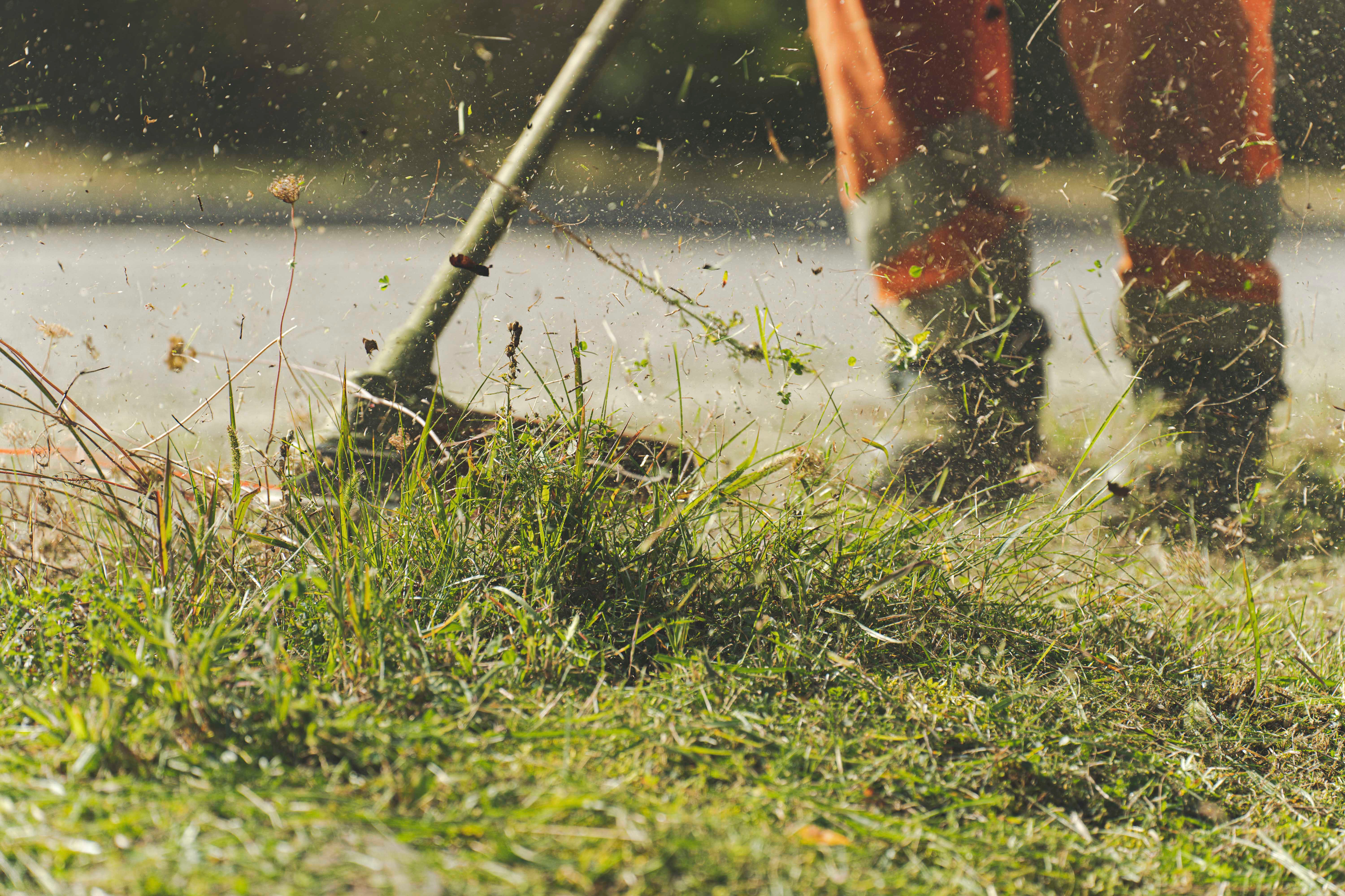 A man operating a weed wacker